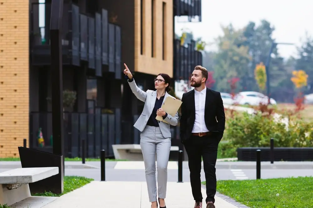 Property consultants in Dubai walking a client through a residential development