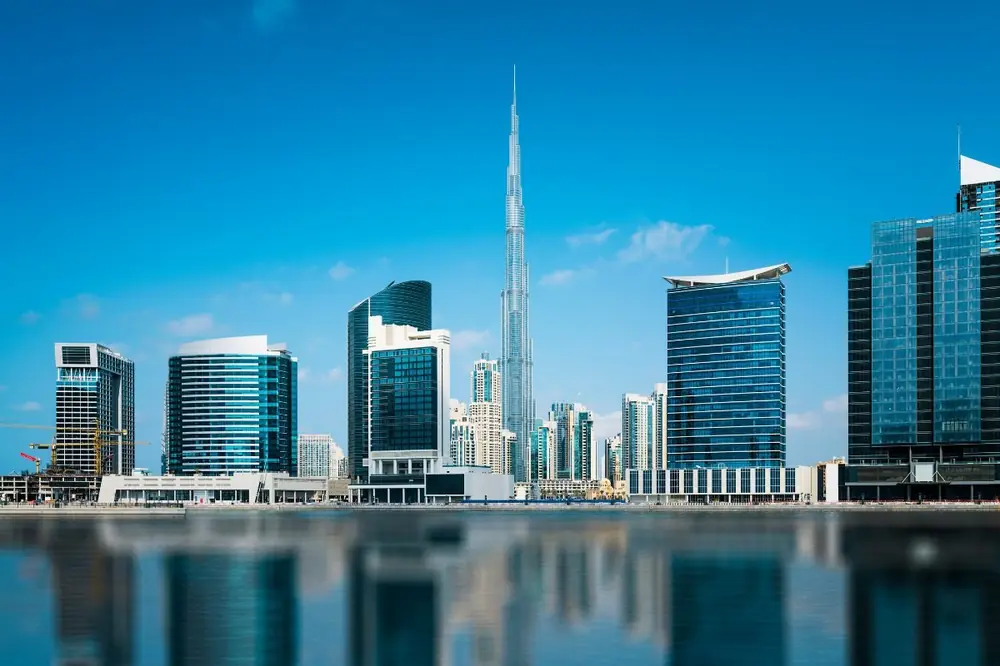 Dubai skyline of premium investment towers under a warm sky